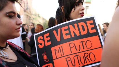 "My fucking future for sale," says a placard protesting cuts to Spain's education budget in 2016.