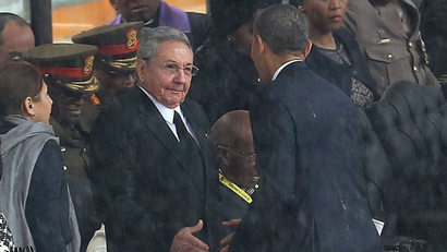 Raul Castro and Barack Obama shake hands at Nelson Mandela's funeral.
