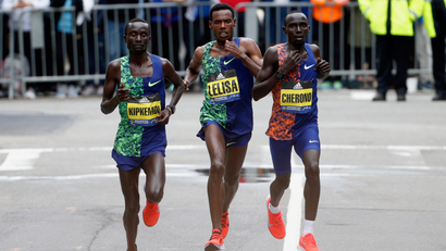 Kenneth Kipkemoi, Lawrence Cherono, and Lelisa Desisa racing to the finish during the 2019 Boston Marathon.