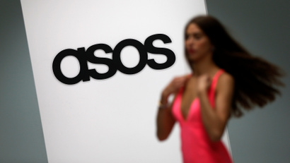 A model walks on an in-house catwalk at the ASOS headquarters in London April 1, 2014. REUTERS/Suzanne Plunkett/File Photo