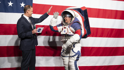 NASA Administrator Jim Bridenstine, left, high fives Kristine Davis, a spacesuit engineer at NASA’s Johnson Space Center, wearing a ground prototype of NASA’s new Exploration Extravehicular Mobility Unit (xEMU), during a demonstration of the suit, Tuesday, Oct. 15, 2019 at NASA Headquarters in Washington. The xEMU suit improves on the suits previous worn on the Moon during the Apollo era and those currently in use for spacewalks outside the International Space Station and will be worn by first woman and next man as they explore the Moon as part of the agency’s Artemis program.