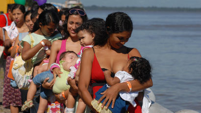 Brazilian mothers breast-feed their babies during an event organized to coincide with the opening of the Tenth National Conference on Breastfeeding