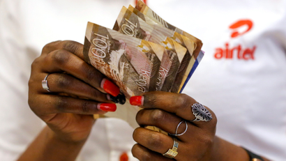 An employee counts money inside a mobile phone service centre operated by Kenyan telecom operator Airtel Kenya in January.