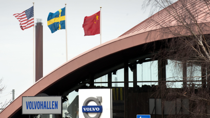 The flags of China, Sweden and the United States wave outside the Volvo Hall at the Volvo plant and headquarters in Torslanda, Gothenburg
