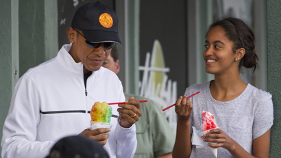 President Barack Obama eats shave ice with daughter Malia Obama at Island Snow, Thursday, Jan. 1, 2015, in Kailua, in Hawaii during the Obama family vacation.