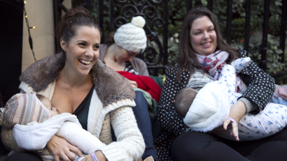 Demonstrators feed their babies during a protest in support of breastfeeding in public, outside Claridge's hotel in London