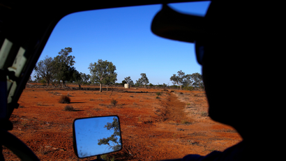 A farmer looks out on the dry landscape of Queensland, Australia