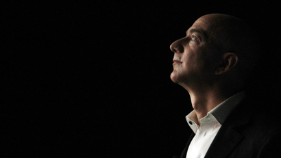 Amazon CEO Jeff Bezos looks up into darkness