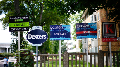Estate agents boards are lined up outside houses in south London