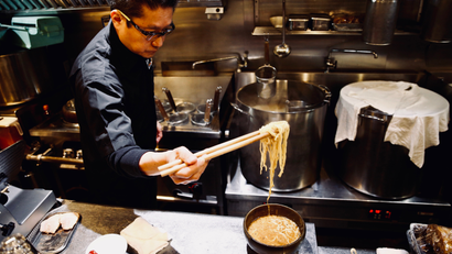 Kenji Saito cooks at his ramen noodle shop in Tokyo.