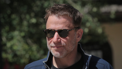 Stewart Butterfield wears sporty sunglasses and generally looks unconcerned.