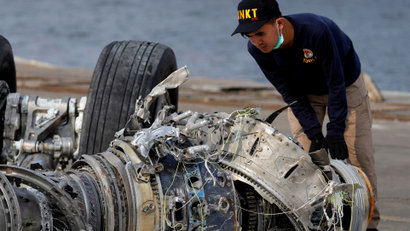 An Indonesian investigator examines a turbine engine from Lion Air flight JT610.