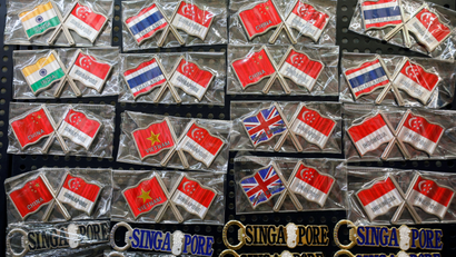 An image of souvenir pins featuring flags of China, Indonesia, India, Thailand, Vietnam and the United Kingdom in Singapore