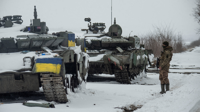 Ukrainian serviceman stands near captured Russian tanks in the north of the Kharkiv region