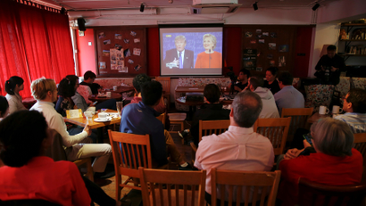 People watch a direct broadcast of the first U.S. presidential debate between Republican U.S. presidential nominee Donald Trump and Democratic U.S. presidential nominee Hillary Clinton at a cafe in Beijing