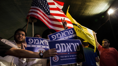 Israelis wave flags and hold signs during a rally, sponsored by Republicans Overseas Israel