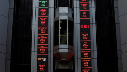 An elevator travels next to electronic boards displaying stock figures at the National Stock Exchange (NSE) building in Mumbai