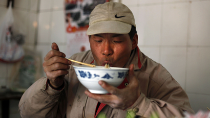 opiate opium heroin drug narcotic noodle morphine food safety xi'an china ganmian A migrant worker eats noodles in a local restaurant in Shanghai March 11, 2010. REUTERS/Nir Elias