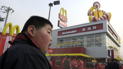 A Chinese child looks on at a new McDonald's drive-thru outlet built next to a gas station in Beijing, China, Friday, Jan. 19, 2007.