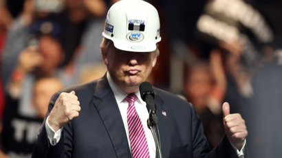 Republican presidential candidate Donald Trump puts on a miners helmet during a rally in Charleston, W.Va., Thursday, May 5, 2016. (AP Photo/Steve Helber)