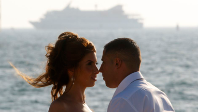 A bride and groom pose for their wedding photographer as Mavi Marmara is escorted to Ashdod port