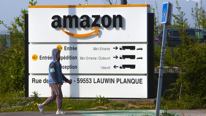 A man walks at the entrance of Amazon, in Douai, northern France