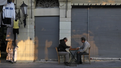 Shop owners play backgammon in the Plaka area of central Athens.