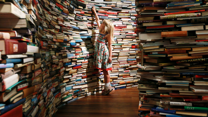 girl surrounded by stacks of books
