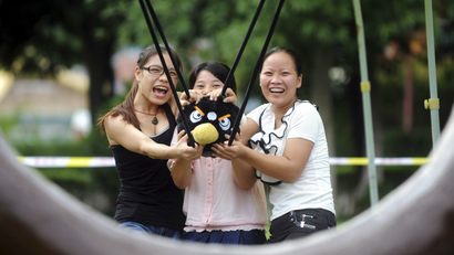 Visitors use a slingshot to shoot an Angry Bird plush toy at a real life Angry Birds outdoor game in a theme park at Changsha, Hunan province September 1, 2011.