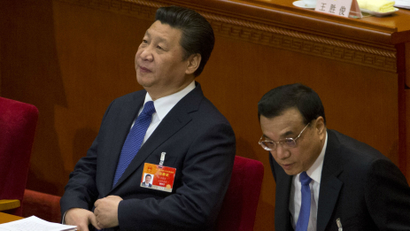 Chinese President Xi Jinping, left, and Chinese Premier Li Keqiang, right, attend a plenary session of the National People's Congress in the Great Hall of the People in Beijing, Thursday, March 12, 2015. (AP Photo/Ng Han Guan