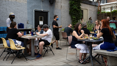 Customers drink and dine outdoors at the restaurant "Martha" in Philadelphia, Pennsylvania, US