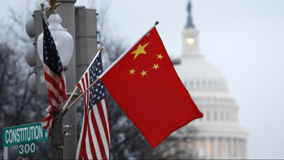 The People's Republic of China flag and the U.S. Stars and Stripes fly on a lamp post along Pennsylvania Avenue near the U.S. Capitol in Washington during Chinese President Hu Jintao's state visit, January 18, 2011. Hu arrived in the United States on Tuesday for a state visit with U.S. President Barack Obama that is aimed at strengthening ties between the world's two biggest economies. REUTERS/Hyungwon Kang