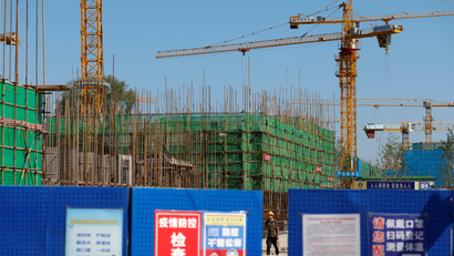A worker walks inside the construction site of a project developed by China Evergrande Group in Beijing, China