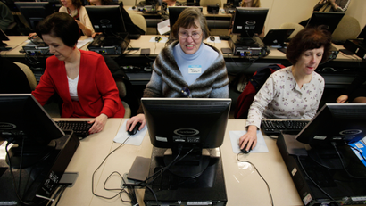 Sue Carter, left, Cheri Rinehart, center, and Loraine Terpening, right, work on computers, Monday, April 13, 2009, in a training lab at a WorkSource office in downtown Seattle, as they wait to hear about a program that will provide more than 30,000 training vouchers to workers and those seeking work in Washington state to pay for training courses ranging from basic technology literacy to intermediate-level technology skills. The program is a partnership between Microsoft, the state's Employment Security Department and the Workforce Development Council of Seattle-King County. (AP Photo/Ted S. Warren)
