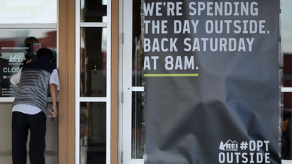 A sign saying an REI store is closed for Black Friday