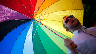 man with rainbow umbrella