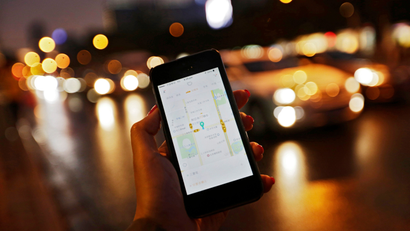 A file picture dated 22 September 2015 shows a view of Didi Kuaidi's smartphone app for customers shown on a mobile phone along a road in Beijing, China. US technology giant Apple has invested 1 billion US dollar in the Chinese ride-sharing company Didi Chuxing (formerly Didi Kuaidi), a rival of Uber in China, the company said in a statement on 13 May 2016. Apple's investment is the largest received by the Chinese company, a leading ride-sharing company in the local market with a share of 87 percent owing to its 300 million users, who hire 11 million rides daily.