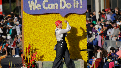 A Rosie The Riveter figure is seen aboard the Wells Fargo float in the 125th Rose Parade in Pasadena, Calif., Wednesday, Jan. 1, 2014. (AP Photo/Reed Saxon)