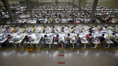 Labourers work at a garment factory in Bac Giang province, near Hanoi October 21, 2015. REUTERS/Kham/File Photo