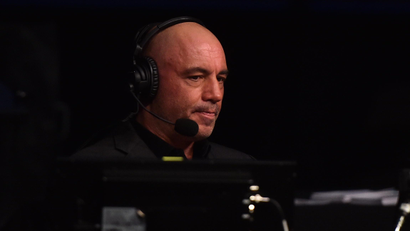 Comedian and podcast host Joe Rogan in headphones before a microphone