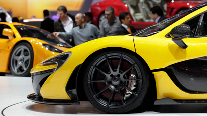 The McLaren P1 car (front) is pictured during the second media day of the 83rd Geneva Car Show at the Palexpo Arena in Geneva March 6, 2013. The Geneva Motor Show will take place from March 7 to 17, 2013. REUTERS/Denis Balibouse (SWITZERLAND - Tags: TRANSPORT BUSINESS) - RTR3EN6R