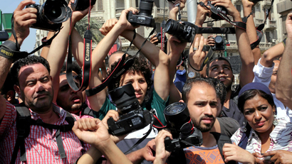 FILE PHOTO: Egyptian journalists hold up their cameras outside the Egyptian Press Syndicate in downtown Cairo, Egypt April 28, 2016.