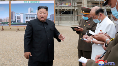 North Korean leader Kim Jong Un speaks at a hospital under construction