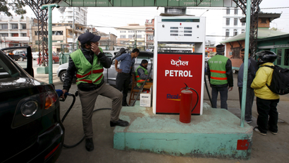 A petrol pump attendant puts petrol priced at 99 Nepali rupees ($0.91) per litre into a car at a Saja Petrol gas station in Kathmandu, Nepal