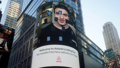 The NASDAQ market site displays an AirBnb sign featuring CEO Brian Chesky on their billboard on the day of their IPO in Times Square in the Manhattan borough of New York City, New York, U.S., December 10, 2020.