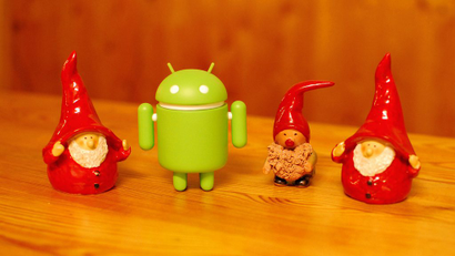 Google's Android mascot with Santa Claus figurines.