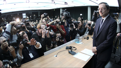 Mario Draghi, President of the European Central Bank, is surrounded by photographers prior to a press conference in Frankfurt.