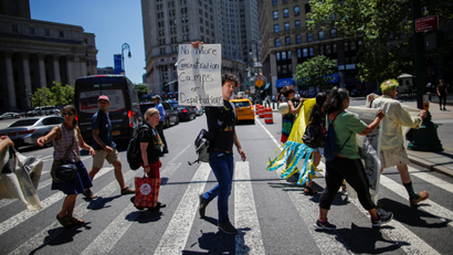 People take part in a protest against family deportations near ICE's offices at the federal building in Manhattan.