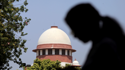 A woman checks her mobile phone inside the premises of the Supreme Court in New Delhi