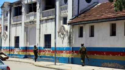 Armed policemen walk outside the central police station after an attack, in the coastal city of Mombasa, Kenya, September 11, 2016.